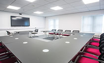 Large U-shape table with red chairs